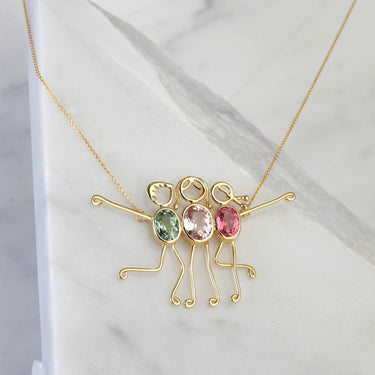 Tourmaline family necklace in 18K gold setting, symbolizing love and protection.