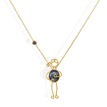 Handmade 18k gold necklace with blue sapphire and black diamond, symbolizing love and strength.