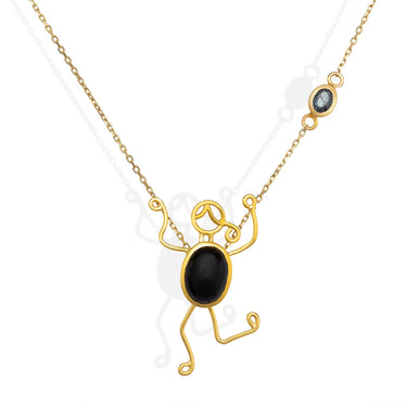 18k gold necklace with black onyx and blue sapphire character design.