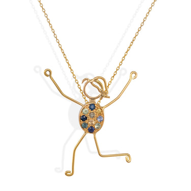 handmade 18k gold necklace with character pendant and sapphire accents