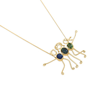 Family-themed gold necklace with blue sapphire gemstones symbolizing love and strength.