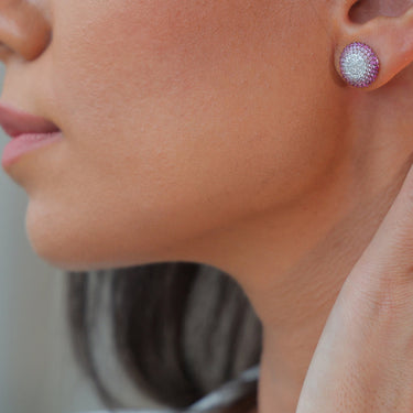 Sapphire and diamond Geomuse earring in 18k gold on ear.