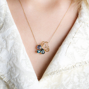 Exquisite LUMINUS WINGS necklace with butterfly charm adorned by 3 spinel stones, crafted in 18k gold.