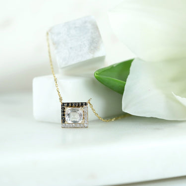 18k gold GEOMUSE necklace with l-shaped morganite and white and black diamonds.