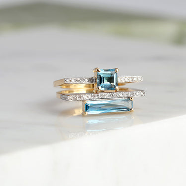 18k gold GEOMUSE ring with princess cut blue topaz and diamonds.
