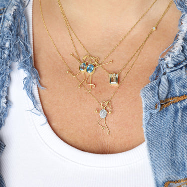 GEOMUSE FLOWER NECKLACE in 18k gold with aquamarine, diamond accents, and handmade flower design.