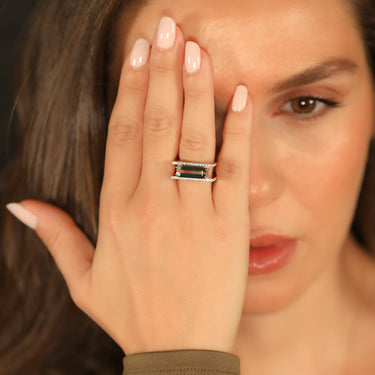 Green tourmaline geometric ring with diamonds set in 18k gold.