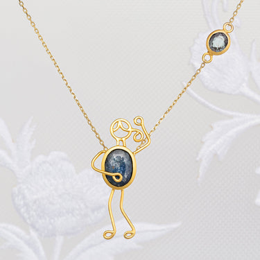 Handmade 18k gold necklace with blue sapphire symbolizing love and strength.