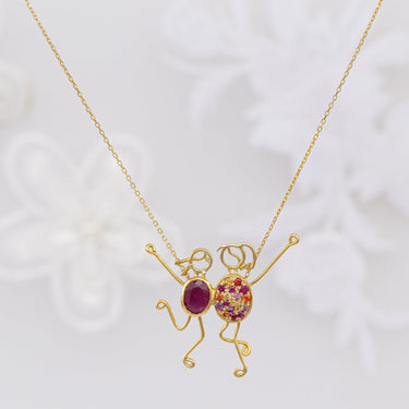Handmade SUSAN & EVA 18k gold necklace with sapphire and ruby accents.
