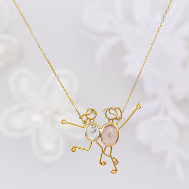 Handmade LISA & ZOE necklace in 18k gold with aquamarine and rose quartz, symbolizing mother-child bond.