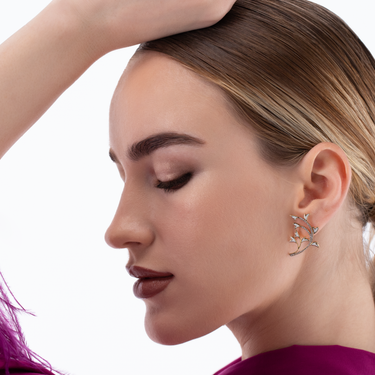 Peacock earrings in 18k gold with diamonds and white enamel.