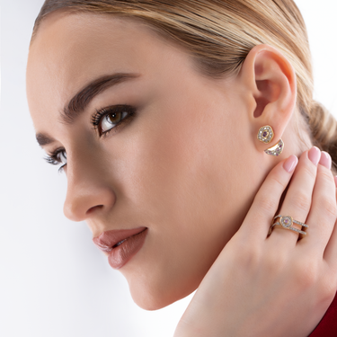 Elegant gold DESERT ROSE RING with pink sapphire and diamonds worn by model.