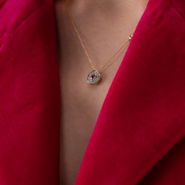 Desert Rose Pendant with dark pink sapphire and diamonds on 18K gold chain.