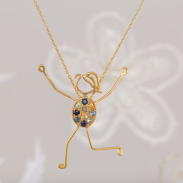 handmade 18k gold character necklace with sapphires