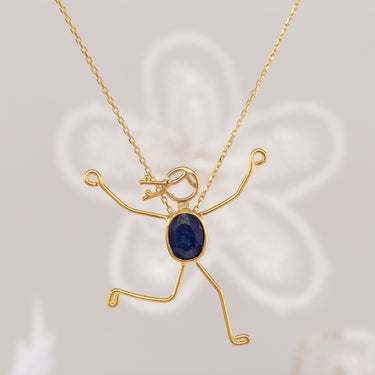 Handmade 18k gold necklace with blue sapphire, symbolizing love and strength for mother and child.