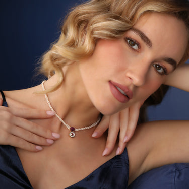 Elegant pearl necklace with a desert rose pendant, star ruby, diamonds, and 18K gold.