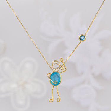 Handmade 18k gold necklace with blue topaz, symbolizing love and connection.